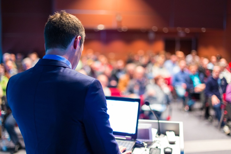A keynote speaker gives a talk at a conference