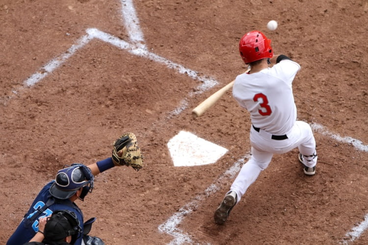 A baseball player stands at bat